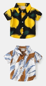 Close-up of boys' short-sleeved shirts with lemon prints and abstract brush patterns