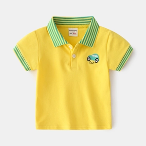Flat lay of a yellow boys' short-sleeved cotton polo shirt with green car embroidery