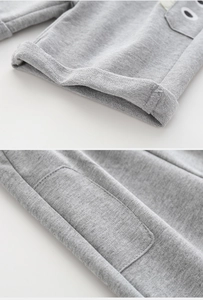 Detail of grey kids shorts with cartoon eye patch and cuffed hem texture