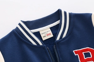 Detail of boys baseball jacket ribbed collar with warm fleece lining and embroidered letter B