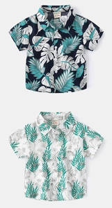 Detail of kids short-sleeve shirts showing tropical plant prints and collar buttons
