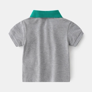 Grey boys' pique polo shirt with vibrant green contrast collar and minimalist back view