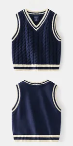 Detail of navy blue V-neck cable-knit sweater vest with white contrast striped edges