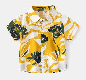 Detailed macro view of yellow floral pattern and white buttons on kids beach shirt