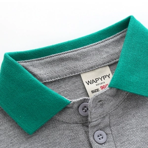 Boys grey polo shirt with green collar detail and premium pique cotton texture