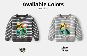 Detail showing kids striped sweatshirts with cartoon dinosaur prints in grey colors