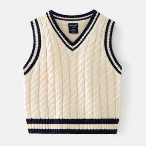 Detailed view of kids V-neck cable knit vest with navy blue stripe trim on neckline
