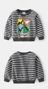 Detail of grey striped kids sweatshirt featuring colorful cartoon dinosaur prints and round neck