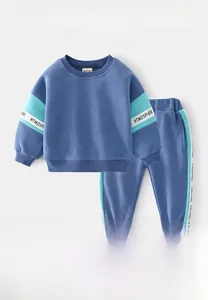 Detail of boys' blue tracksuit featuring letter print and ribbed cuffs for autumn wear
