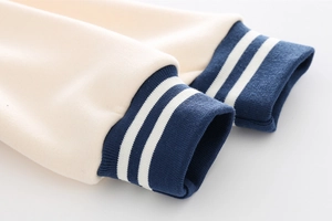 Detailed macro view of striped ribbed cuffs on children's baseball jacket sleeve