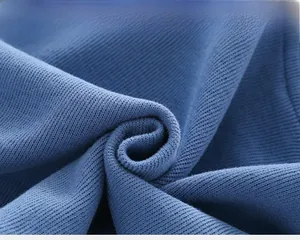 Close-up of premium blue ribbed knit fabric texture on kids sweatshirt and pants set