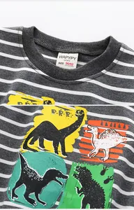Close-up of children's striped sweater showing cotton texture and colorful dinosaur prints