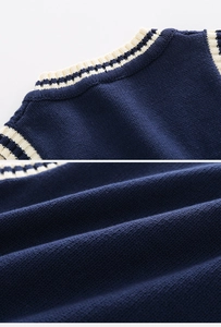 Close-up of navy blue knit vest showing neckline ribbing and soft texture