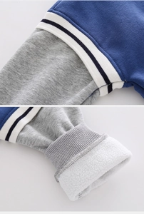 Detail of kids fleece hoodie showing warm white sherpa lining and ribbed cuffs