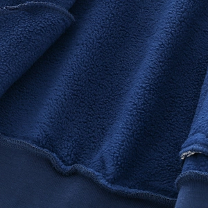 Boys winter baseball jacket featuring thick dark blue fleece lining and ribbed sewing details