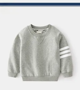 Detail of gray boys' cotton sweatshirt showing ribbed neck and white sleeve stripes