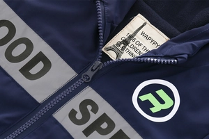 Detail of navy windbreaker showing fleece lining and gray reflective safety strips