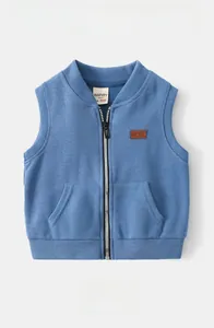 Detail of blue knitted kids vest with striped texture, zipper closure and leather patch