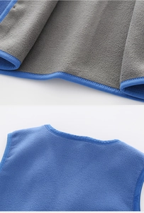 Detail of blue fleece kids vest with grey polar fleece lining and smooth edge seams