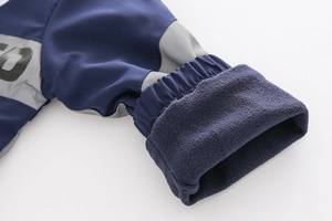 Detail of children hoodie sleeve with reflective stripe, elastic cuff and fleece lining