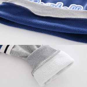 Thick fleece lining detail of boys' winter sweatshirt with ribbed cuffs and soft fabric