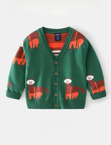 Detail of child knit cardigan with alpaca patterns, V-neck, and wood-like buttons