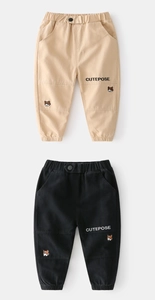 Detail of kids cargo pants in khaki and black with Corgi embroidery and ribbed cuffs