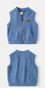 Detail of blue knitted toddler vest featuring full zipper and symmetrical front pockets