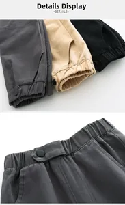 Detail showing elastic waistband with button and side pockets on boys cargo pants