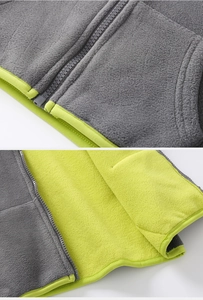 Detail of fleece hoodie with contrast lime lining and high-quality resin zipper
