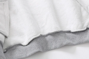 Detail of warm white sherpa fleece lining and grey ribbed hem on boys jacket