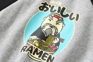 Detail of boys' fleece baseball jacket featuring a Japanese ramen cartoon print