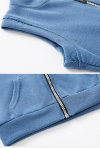 Detail of blue knitted toddler vest featuring a sturdy metal zipper and ribbed texture