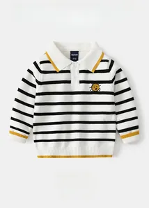 Detailed view of striped boy sweater featuring a sun embroidery and yellow contrast trim