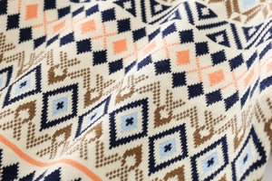 Detailed close-up of thick checkered jacquard knit fabric on a boys' winter sweater