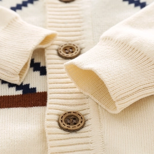 Kids knitted cardigan with navy geometric patterns and wooden buttons in soft cream white