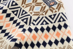 Detail of boys' thick argyle knit sweater showing premium geometric jacquard texture