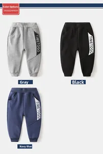 Detailed view of children's thick joggers in grey, black, and navy with side lettering