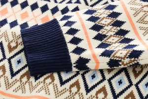 Macro shot of thick knit fabric with geometric patterns and ribbed blue cuffs