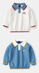 Close-up of knit cotton boys' sweaters with rainbow embroidery and polo lapel collars