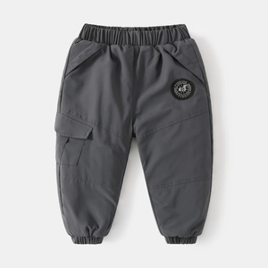Detail of dark grey kids cargo pants featuring elastic waist and utility side pockets