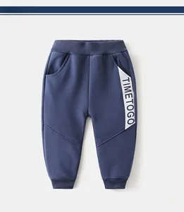 Detail of navy kids winter sweatpants showing elastic waistband and TIMETOGO print