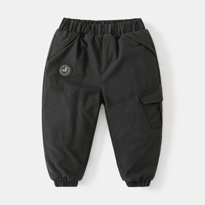 Detail of kids black winter cargo pants with elastic waist and embroidered badge logo