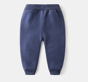 Detail of navy blue fleece-lined kids sweatpants with elastic waist and ribbed ankle cuffs