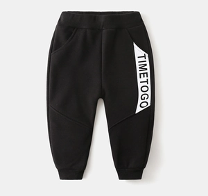 Detail of kids black fleece jogger with TIMETOGO text print and elastic ankle cuffs