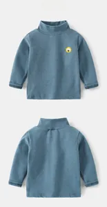 Detail view of children's fleece turtleneck shirt with cute lion embroidery detail