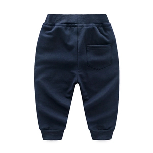 Detail of navy blue kids knit jogger pants featuring an elastic waist and back square pocket