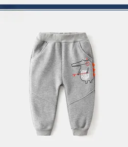Detail of grey toddler joggers with cartoon crocodile print and orange 3D dorsal fins