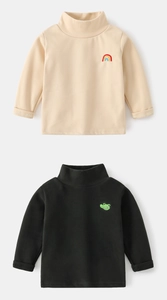 Detail view of high collar kids base layer with rainbow and dinosaur embroidery