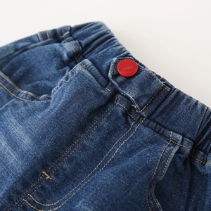 Boy's deep blue washed denim jeans featuring elastic waist and red button detail